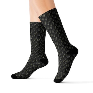 May include: Black and gold dragon scale patterned socks. The socks are shown on a model's legs.
