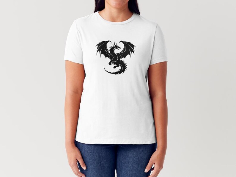 May include: A white t-shirt featuring a black silhouette of a dragon with its wings outstretched.