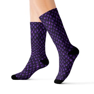 May include: Purple dragon scale patterned socks. The socks are shown on a model's feet.