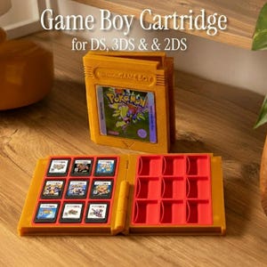 May include: A mustard yellow Game Boy cartridge case with the text "Game Boy Cartridge for DS, 3DS & 2DS". The case is open, revealing a red interior with slots for game cartridges. Several game cartridges are visible.