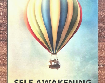 May include: A box of Self Awakening Oracle Cards with a colorful hot air balloon against a blue sky with clouds. The box has a vintage look.