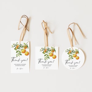 May include: Three white thank you tags with a watercolor illustration of orange blossoms and fruit. The text on the tags reads "Thank you! For making our baby shower so great. Love, Olivia."