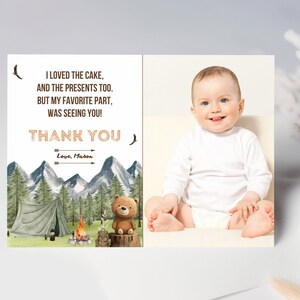 May include: A thank you card with a woodland theme. The card features a green tent, a campfire, a brown bear, and a mountain range. The text on the card reads "I loved the cake, and the presents too. But my favorite part, was seeing you! Thank you. Love, Mason". A photo of a baby boy is on the right side of the card.