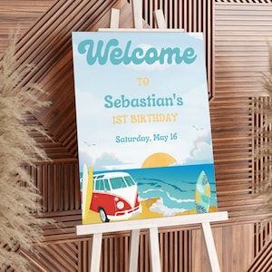 May include: Welcome to Sebastian's 1st Birthday party sign with a retro beach theme. The sign features a vintage van, surfboards, and a sunset over the ocean. The text is in a colourful, retro font.