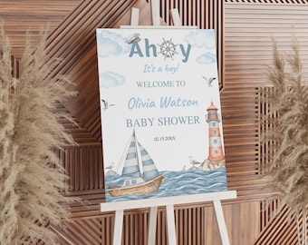 May include: A rectangular baby shower welcome sign featuring nautical illustrations of a sailboat, a lighthouse, seagulls, and clouds. The text reads Ahoy It's a boy! WELCOME TO Olivia Watson BABY SHOWER 02.15.20XX in blue and grey lettering.