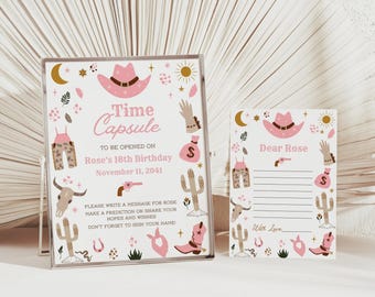 May include: A white sign and matching card featuring pink and brown western-themed illustrations including a cowboy hat, cactus, cow skull, and boots. The sign reads Time Capsule to be opened on Rose's 18th Birthday November 11, 2041, and the card reads Dear Rose.