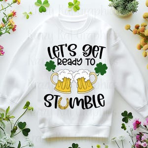 May include: White sweatshirt with a black graphic design that says "Let's get ready to stumble" with two beer mugs and a shamrock.