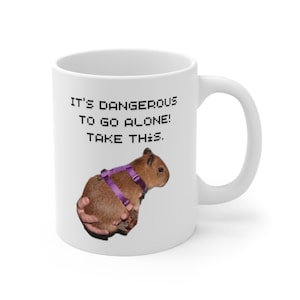 1 Capybara Obtained &quot;It&#39;s Dangerous To Go Alone! Take This.&quot; Video Game Text - Capybara Graphic - Funny Gift - White, Ceramic, 11 fl oz Mug