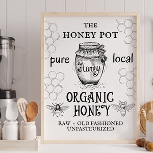 May include: Black and white illustration of a honey jar with the text "The Honey Pot, pure local organic honey, raw - old fashioned unpasteurized". The illustration is surrounded by honeycomb patterns.