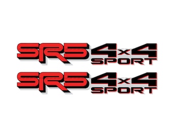 May include: Two red and black SR5 4x4 Sport decals. The SR5 text is in a bold, sans-serif font with a black shadow. The 4x4 Sport text is also in a bold font with a black shadow. The decals are on a white background.