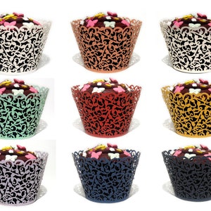 May include: Nine cupcake wrappers in a variety of colours, including white, orange, red, green, purple, yellow, and blue. Each wrapper features a delicate lace design with a butterfly motif.