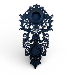 May include: A dark navy blue wall sconce with elaborate, swirling, and floral filigree patterns. The sconce has a circular holder at the top and a decorative, pointed base. The intricate details and dark colour give it a vintage, antique aesthetic.