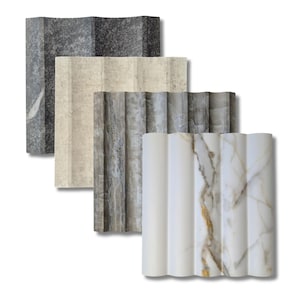 May include: Three samples of decorative wall tiles with a wavy, ribbed texture. The tiles are in a variety of colors and patterns, including gray, beige, and white with gray veining.