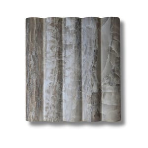 May include: A wavy, light brown and white onyx tile with a rippled surface.