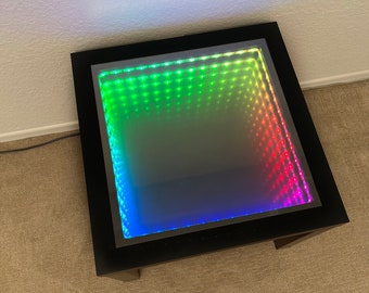 Mesa de centro negra con efecto de luces LED de espejo infinito