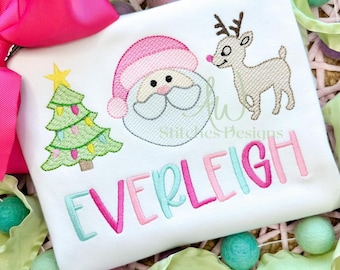 May include: A white onesie with a pink, green, and white embroidered Christmas tree, Santa Claus, reindeer, and the name "EVERLEIGH".