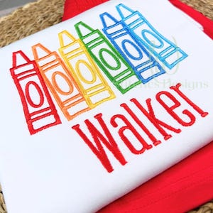 White shirt with colorful crayon design and 'Walker' text on a red background