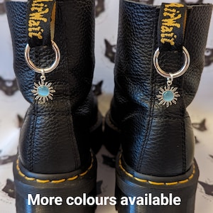 Silver and pearlescent sun boot charms