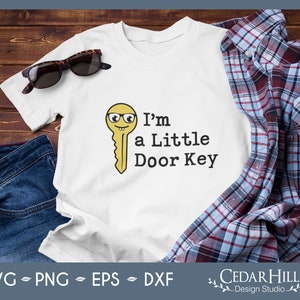 May include: A white t-shirt with a yellow cartoon key wearing glasses and the text "I'm a Little Door Key".