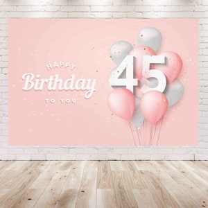 May include: Pink and white birthday banner with the number 45 and the text "Happy Birthday to You" surrounded by pink and silver balloons and confetti.