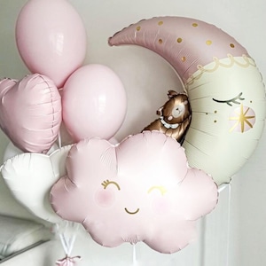 May include: A set of pink and white balloons in the shape of a cloud, a crescent moon, and hearts. The cloud balloon has a smiley face and the moon balloon has a sleeping bear on it.