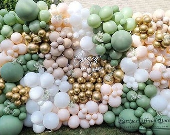May include: A wall decorated with green, white, and gold balloons. The balloons are arranged in a random pattern and spell out the words "Crazy in Love".