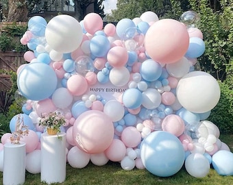 May include: A balloon arch made of blue, pink, and white balloons. The arch is decorated with the words "Happy Birthday".