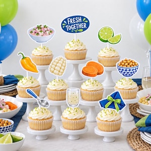 May include: A collection of cupcakes on white stands, each topped with a decorative cutout featuring images of ceviche, a lime, corn, sweet potato, a spoon, a drink, a napkin, and a blue sign with the text FRESH TOGETHER in white letters.