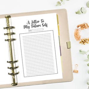Pu&ograve; includere: Una pagina bianca con carta rigata in un raccoglitore beige. La pagina contiene il testo "A Letter To My Future Self" e una riga vuota per la data.