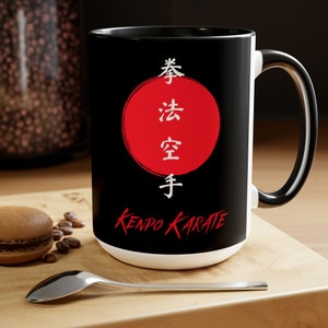 May include: Black and white ceramic mug with a red circle and white Japanese characters that read "Kenpo Karate".