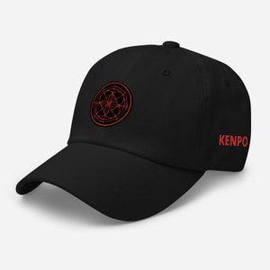 May include: Black baseball cap with a red embroidered geometric design and the word "KENPO" in red on the side.