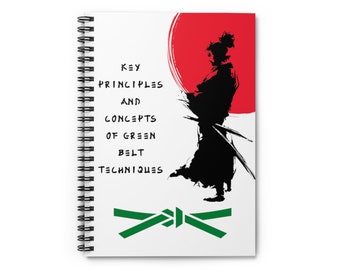 May include: A white notebook with a black and white illustration of a samurai warrior with a red sun behind him. The text "Key Principles and Concepts of Green Belt Techniques" is printed on the notebook.