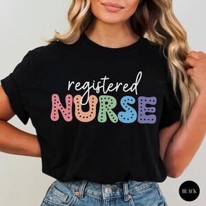 May include: Black t-shirt with the text "registered NURSE" in rainbow colors with black polka dots.