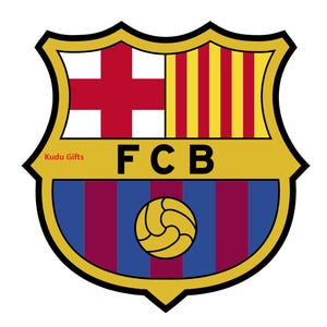 May include: A shield-shaped emblem with a gold border. The top section features a red cross on a white background and vertical yellow and red stripes. The bottom section has blue and maroon vertical stripes with a gold soccer ball. The letters "FCB" are in black.