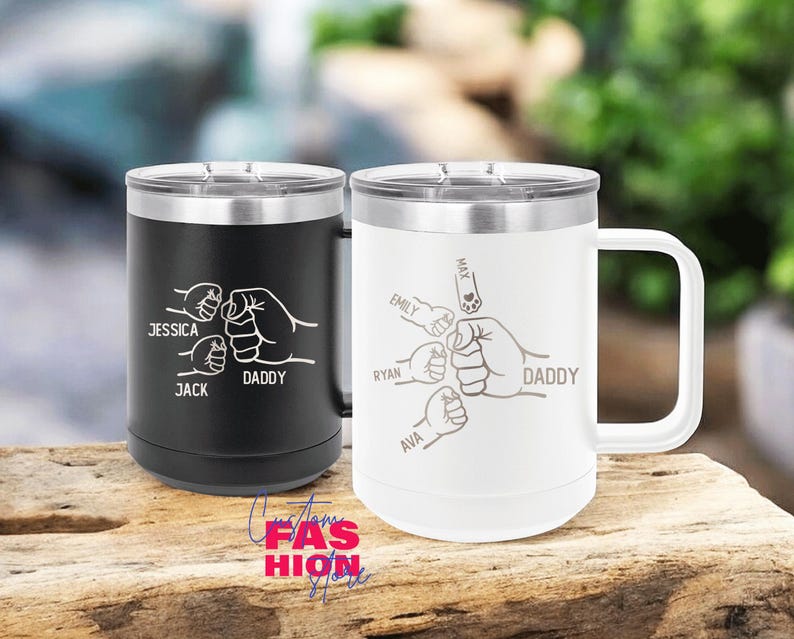 May include: Two stainless steel travel mugs, one black and one white, with silver rims and handles. The black mug has the names "Jessica", "Jack", and "Daddy" with a fist bump design. The white mug has the names "Emily", "Ryan", "Ava", "Max", and "Daddy" with a fist bump design.