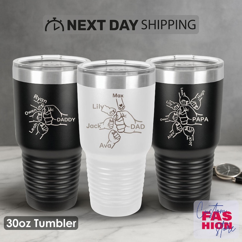 May include: Three 30oz tumblers with personalized designs. One is white, and two are black. Each tumbler features a graphic of hands and names, with the words "DADDY" or "PAPA". The text "NEXT DAY SHIPPING" is at the top.