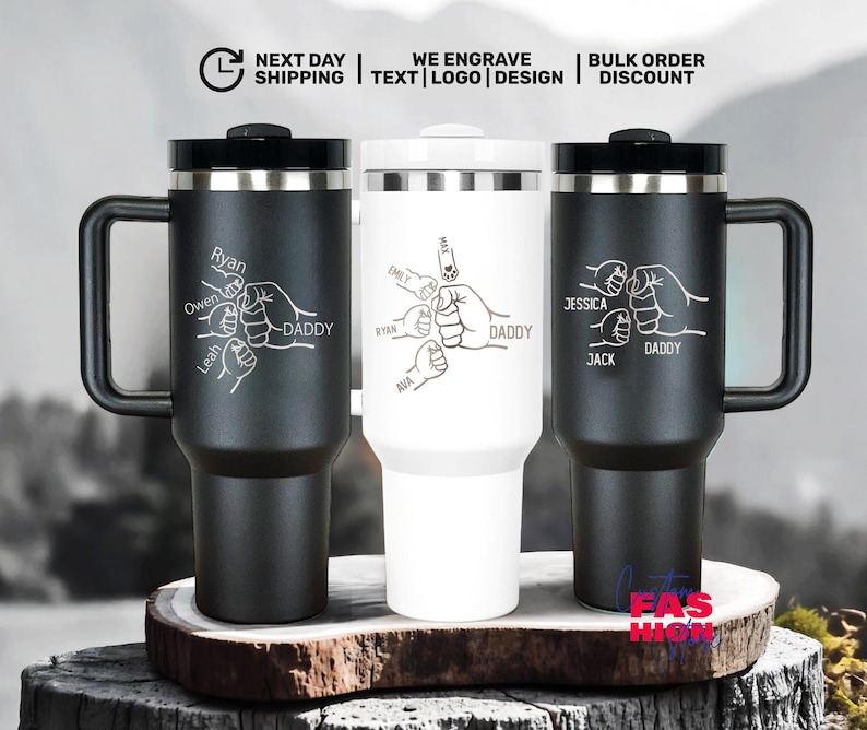 May include: Three insulated travel mugs with black handles and lids. Each mug features a personalized design with names and the word "DADDY" alongside a graphic of clasped hands. The mugs are black and white.