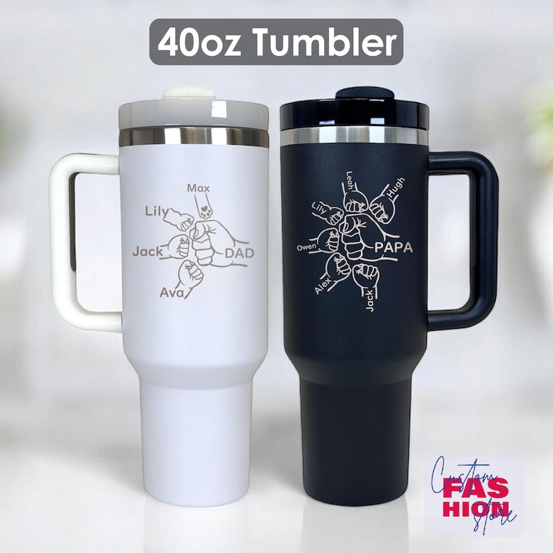 May include: Two 40oz tumblers, one white and one black, with handles and lids. The white tumbler has the word "DAD" and names around a fist graphic. The black tumbler has the word "PAPA" and names around a fist graphic. The text "40oz Tumbler" is at the top.