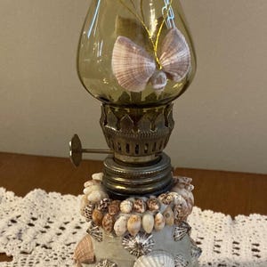 May include: White ceramic mug with a black handle, featuring the text "But First, Coffee" in a handwritten font. The mug is designed for hot drinks, with a capacity of approximately 325-440 ml.