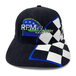 May include: Black baseball cap with a checkered pattern and a blue and green embroidered logo that says "RPM2 NIGHT".
