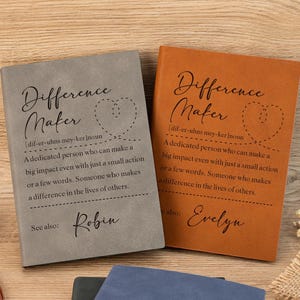 May include: Two brown leather journals with the word "Difference Maker" and a definition of the word. The journals are personalised with the names "Robin" and "Evelyn".