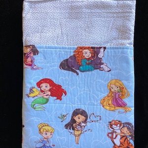 May include: A blue fabric pouch with a white polka dot pattern on the top flap. The pouch features a colorful print of Disney princesses with their animal companions on a light blue background with white hearts.