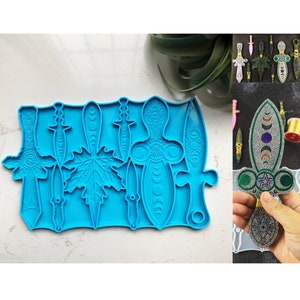 May include: Blue silicone mold with six different shapes: a leaf, a dagger, and four different styles of swords. The swords have moon and star designs.