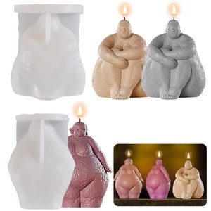 Könnte beinhalten: Eine Sammlung von körperförmigen Kerzen in verschiedenen Farben, darunter Beige, Grau und Rosa, mit einer brennenden Dochtspitze. Das Bild zeigt auch eine weiße Silikonform zur Herstellung der Kerzen. Die Kerzen sind so gestaltet, dass sie einer sitzenden menschlichen Figur ähneln.