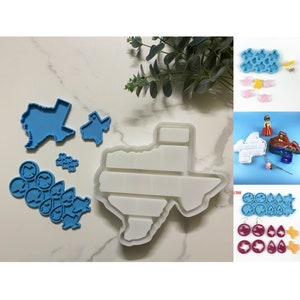 Könnte beinhalten: Eine Sammlung von Silikonformen in verschiedenen Formen, darunter der Bundesstaat Texas und mehrere kleinere Designs. Die Formen sind in Blau- und Weißtönen gehalten, perfekt für Bastelprojekte. Das Bild zeigt auch fertige Harzstücke.