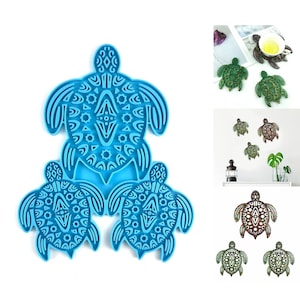 May include: Three blue silicone moulds shaped like turtles with intricate geometric patterns. The moulds are stacked on top of each other.