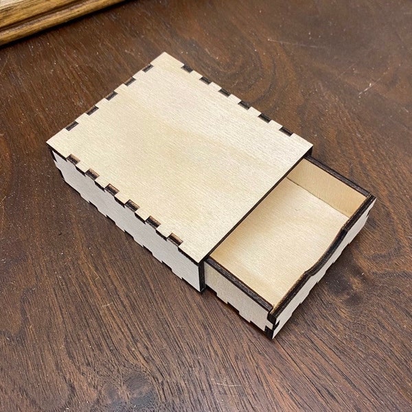 Customizable laser cut boxes (1 3/8”H x 3”W x 3 1/2”L) with removable drawer.