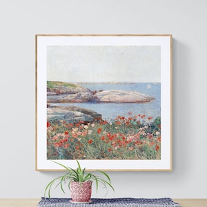 May include: A framed painting of a seascape with a rocky coastline and a field of red flowers in the foreground. The ocean is blue and calm, with two sailboats in the distance.