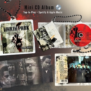 May include: Mini CD album featuring Linkin Park's "Hybrid Theory" album art. The clear plastic case holds a CD and album art. The album art features a black and white insect-like figure. The text "Mini CD Album" is visible.