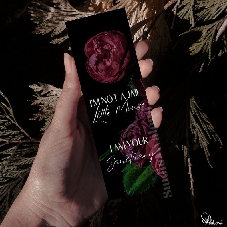 K&ouml;nnte beinhalten: Schwarzer Lesezeichen mit floralem Design und dem Text "I'M NOT A JAIL Little Mouse I AM YOUR Sanctuary". Das Lesezeichen zeigt dunkelrote Rosen und gr&uuml;ne Bl&auml;tter. Das Studio Avalomi-Logo befindet sich unten rechts.